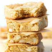 Four stacked Chopped White Chocolate Macadamia Nut Bars