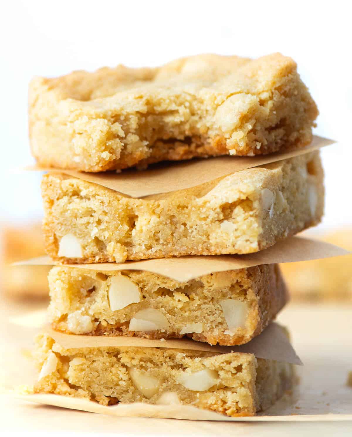 Four stacked Chopped White Chocolate Macadamia Nut Bars