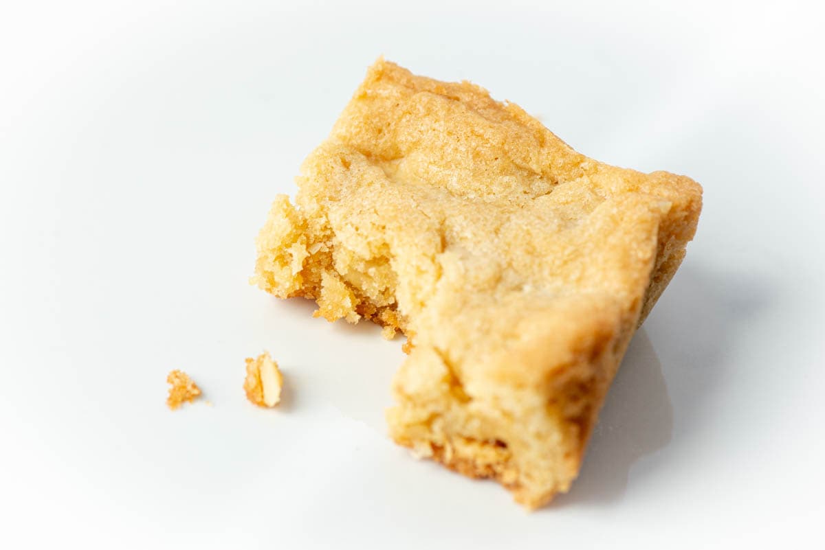 Close up of one Chopped White Chocolate Macadamia Nut Bars with bite