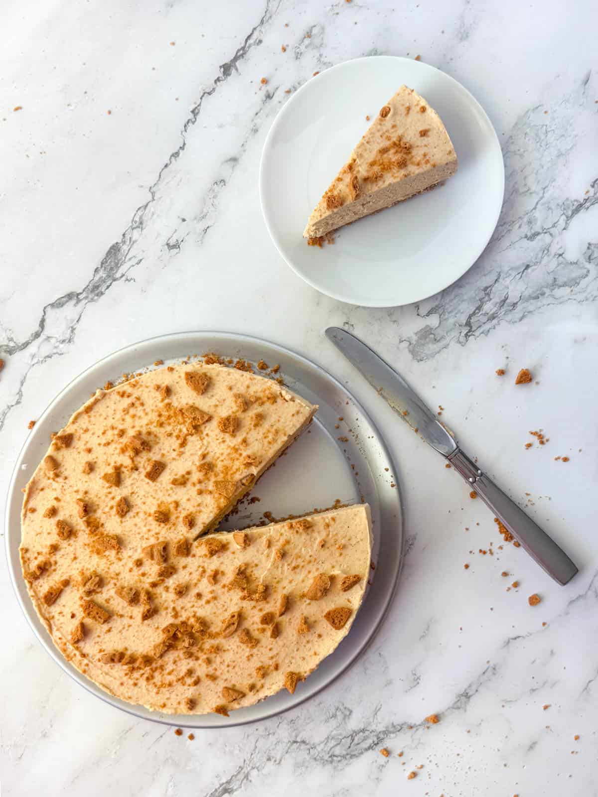 Top view of Gluten Free No Bake Pumpkin Cheesecake with plate and one slice of cheesecake in the background