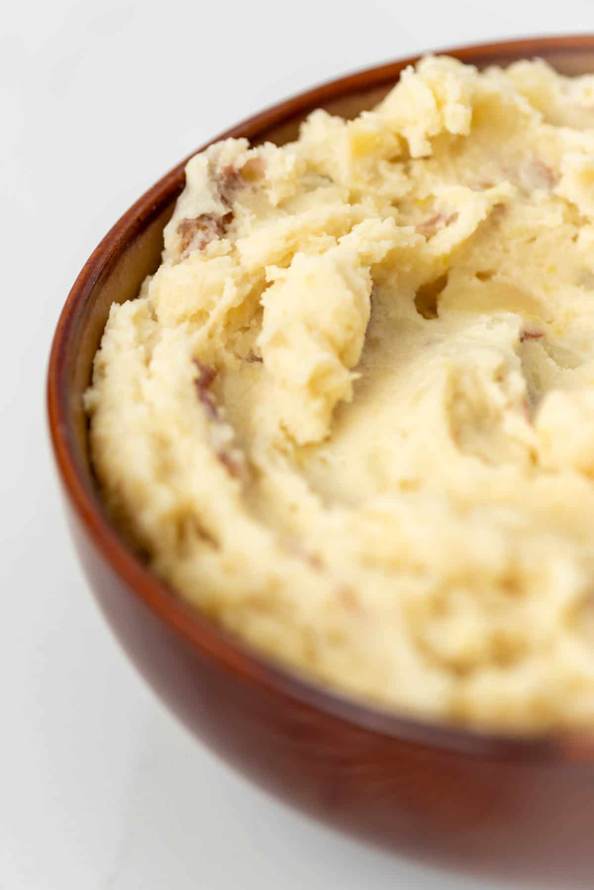 Close up of half of bowl of garlic mashed potatoes