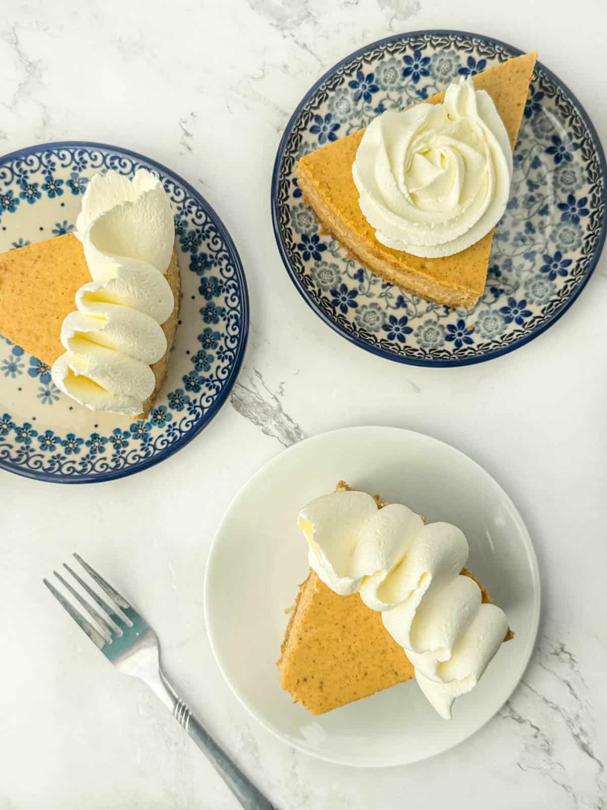 Three difference plates with individual slices of cheesecake