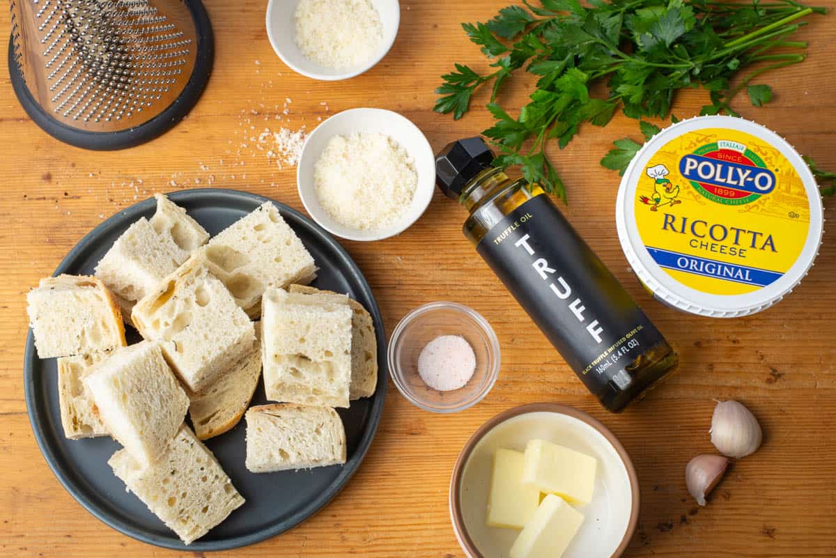 Ingredients needed to make whipped ricotta with truffle oil and garlic bread