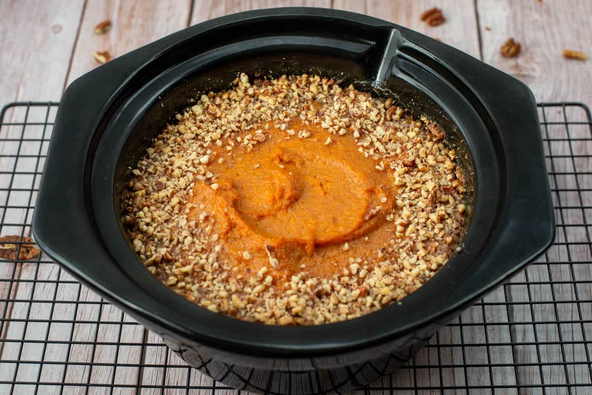 Bourbon sweet potatoes in a crockpot insert on a cooling rack