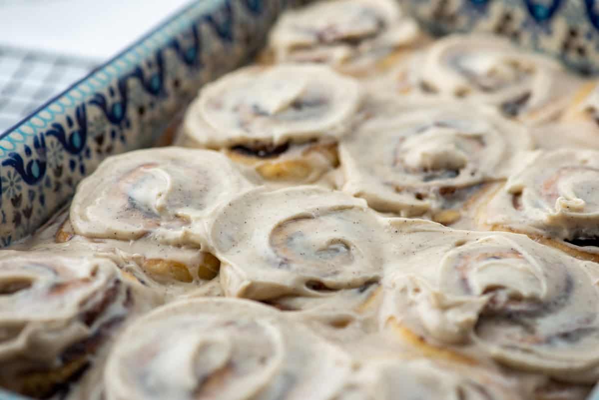 45 degree overhead view of a partial baking pan of chocolate sweet rolls with espresso frosting