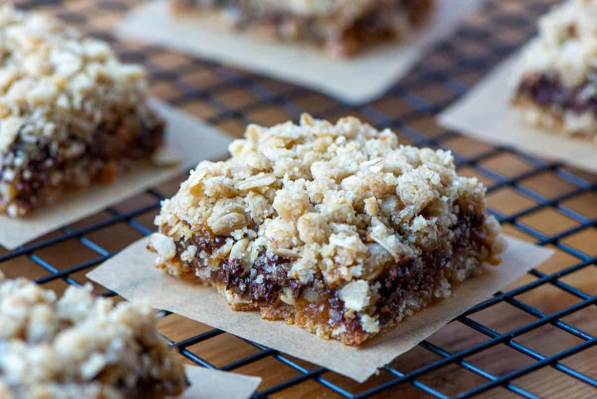 Photo of Carmelitas bars on parchment paper on top of cooling rack