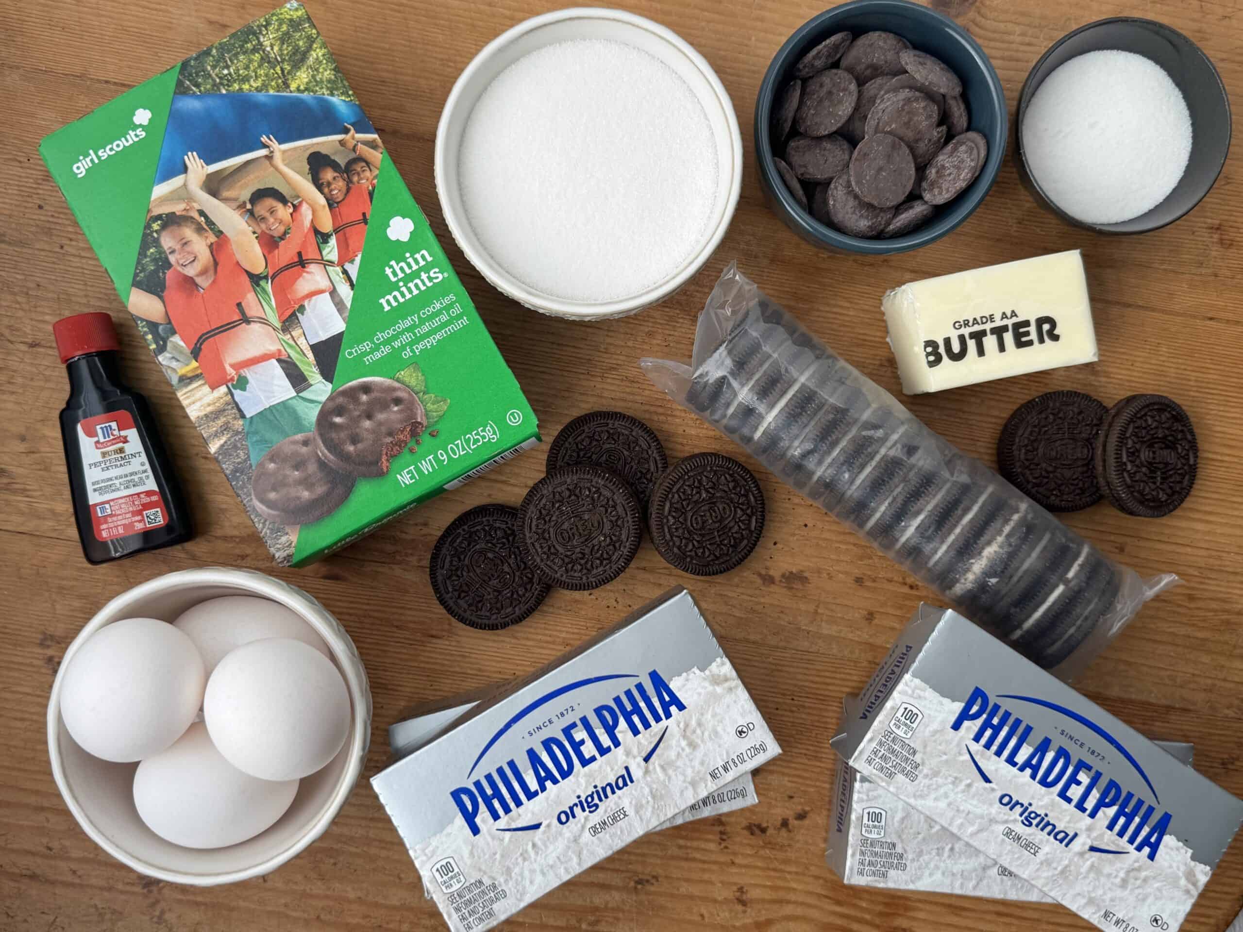 Ingredients needed to make Thin Mints cheesecake: Thin Mints cookies, Oreo cookies, salted butter, white sugar, cream cheese, eggs, peppermint extract, chocolate melting wafers