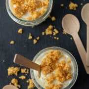 Close up photo of two single serving jars of keto mini lemon cheesecake
