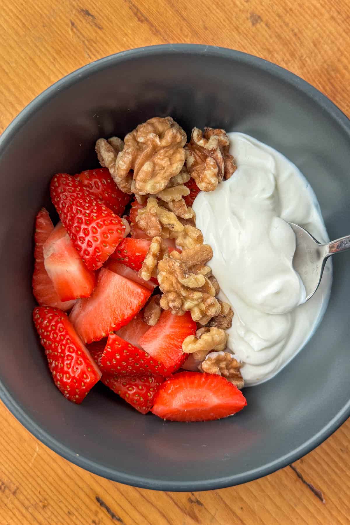 Overhead view of a strawberry, walnuts and greek yogurt bowl