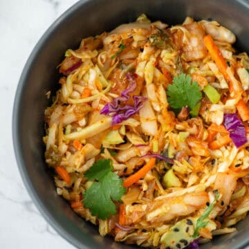 Overhead view of a partial bowl of kimchi slaw in a bowl