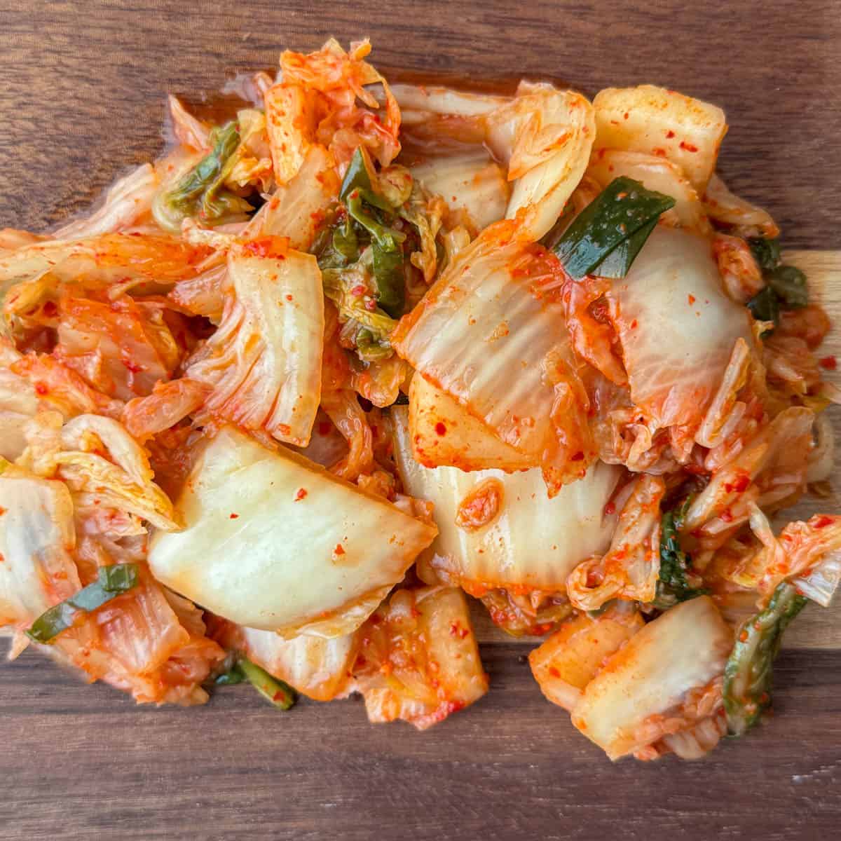 Step 3 of making kimchi slaw: place kimchi on cutting board