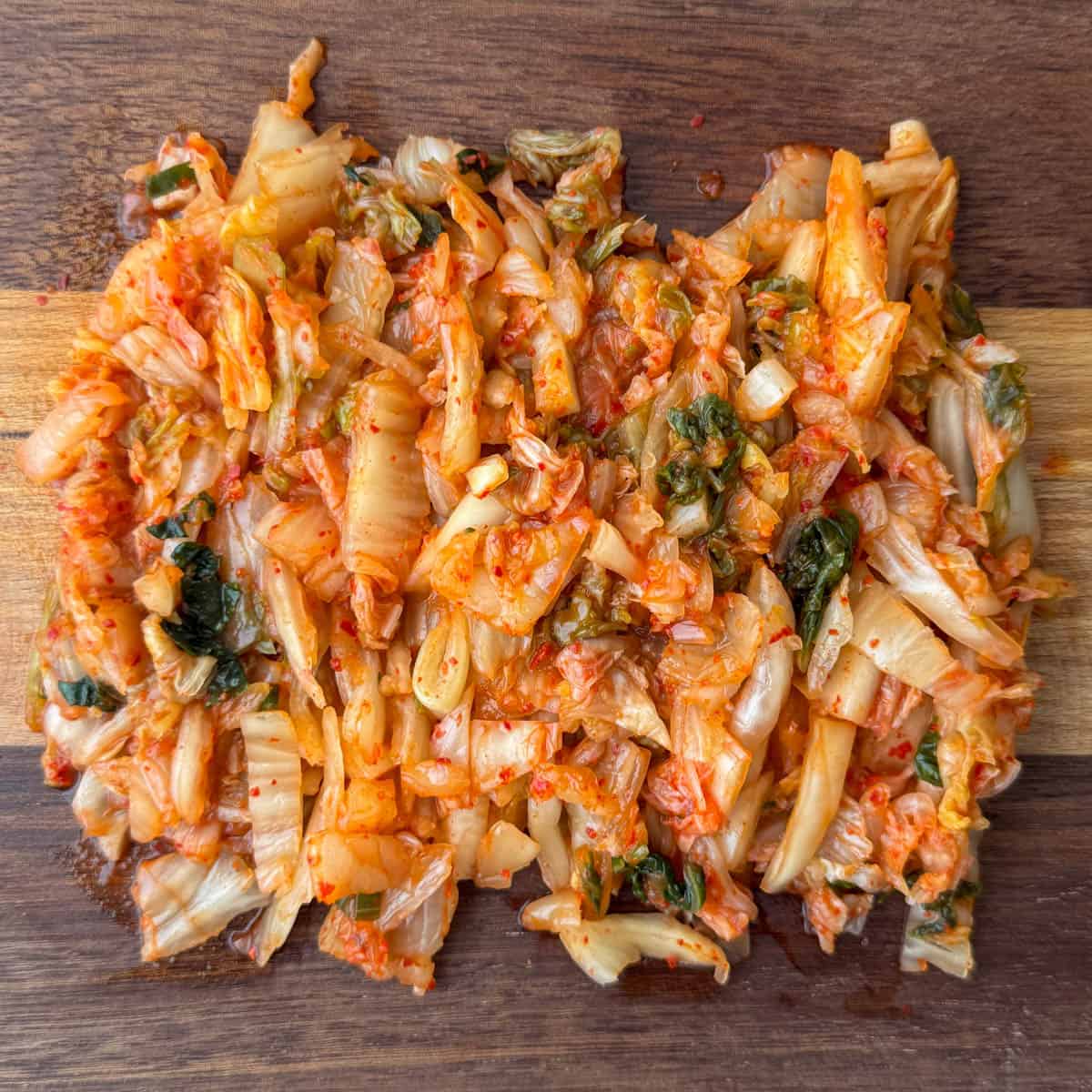 Step 4 of making kimchi slaw: slice kimchi until pieces more like coleslaw pieces