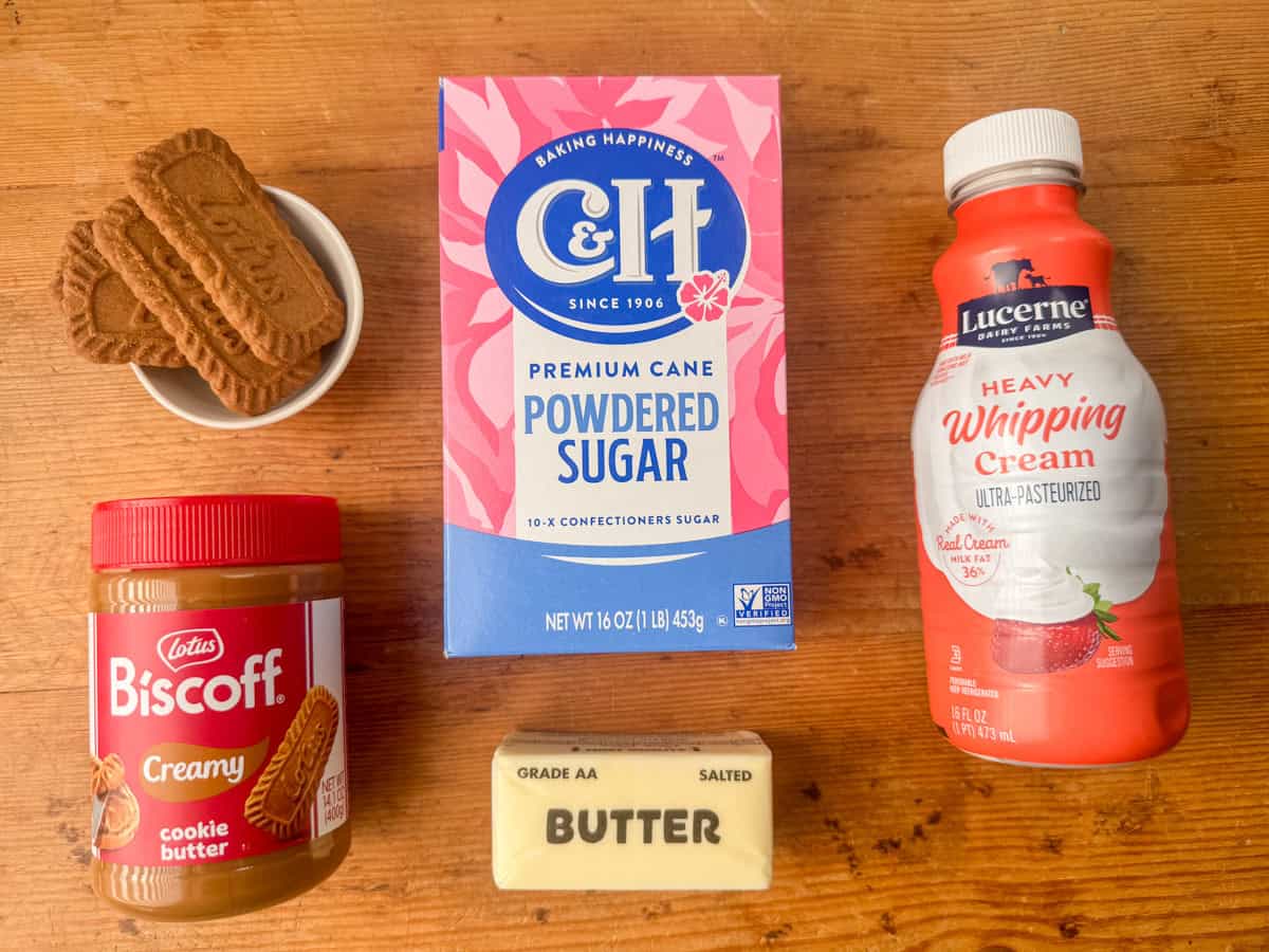 Ingredients needed for Biscoff frosting, drizzle and toppings: powdered sugar, salted butter, cookie butter, heavy whipping cream and Biscoff cookies.