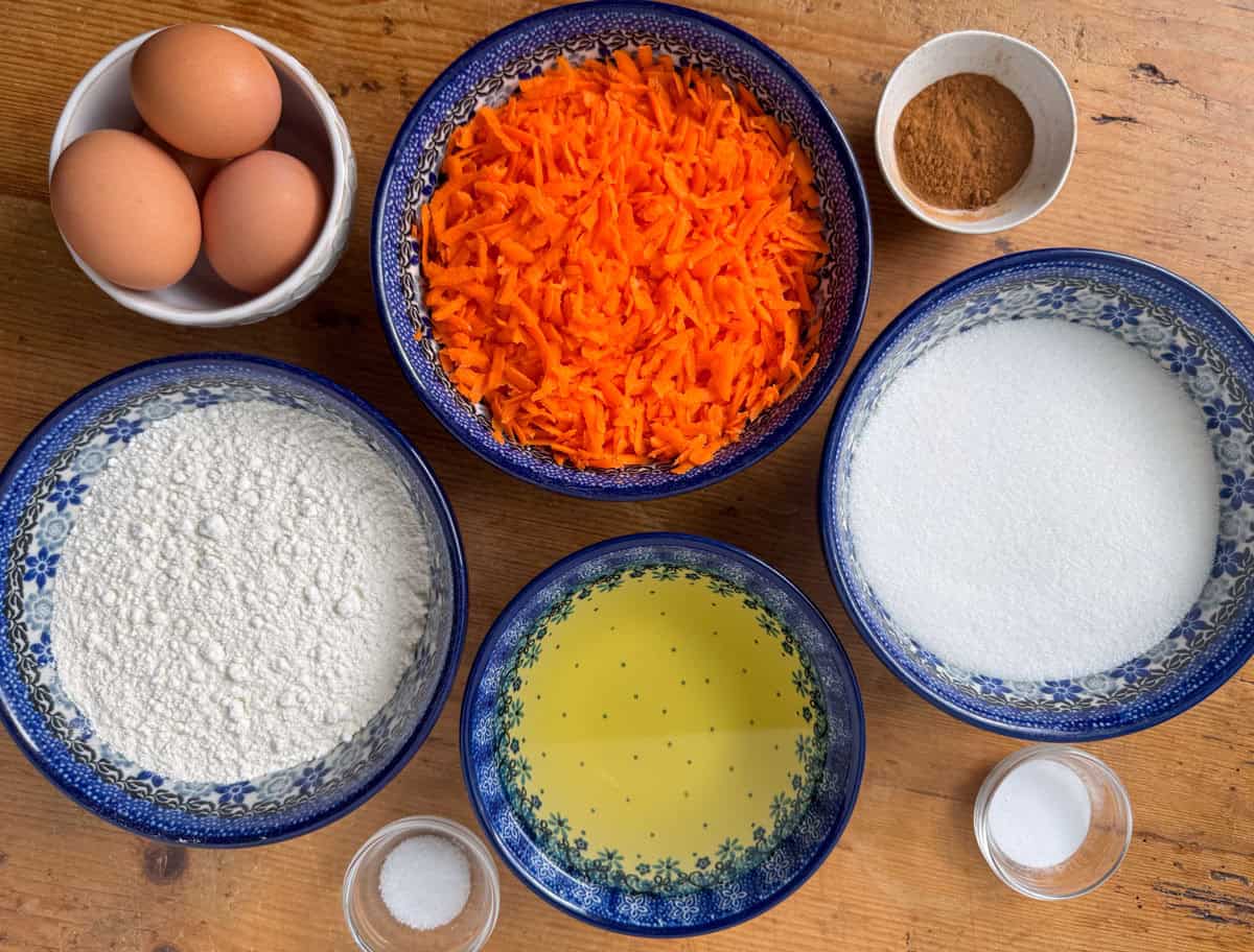 Ingredients needed for carrot cake: shredded carrots, all-purpose flour, white sugar, eggs, olive oil, cinnamon, baking soda and salt