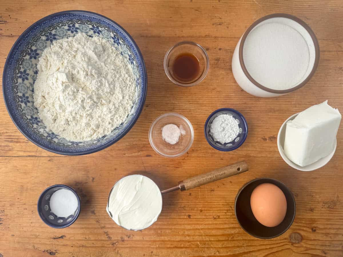 Ingredients needed to make old fashioned sour cream cookies: all purpose flour, white sugar, sour cream, vegetable shortening, an egg, baking soda, baking powder, almond or vanilla extract and salt.