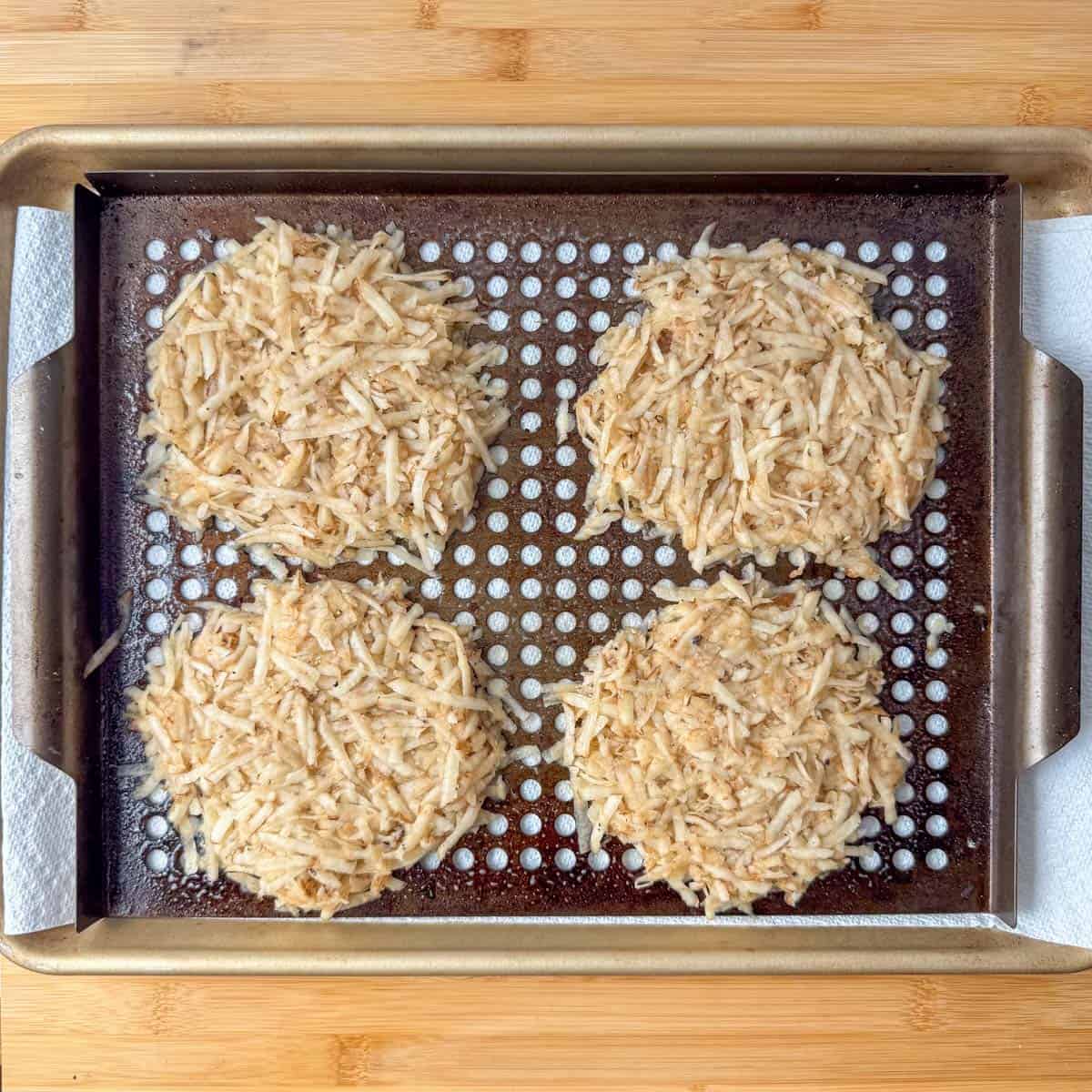 Overhead view of hash brown patties on a grill rack before going on the grill 