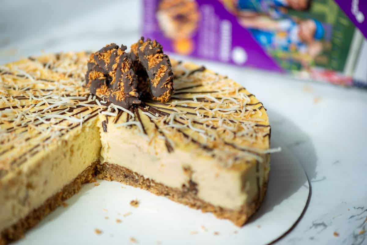 Side view of a cut Samoas Cheesecake