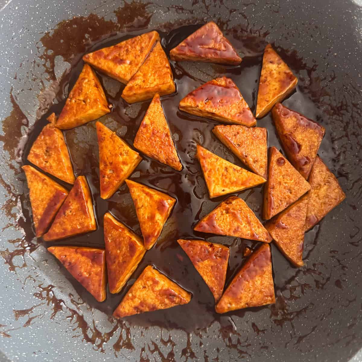 Overhead photo of pan-seared tofu with the stir fry sauce in the pan