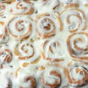 Overhead view of a partial pan of mini cinnamon rolls