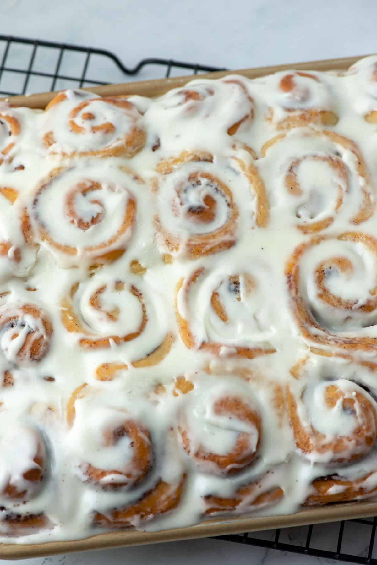Overhead view of a partial pan of mini cinnamon rolls