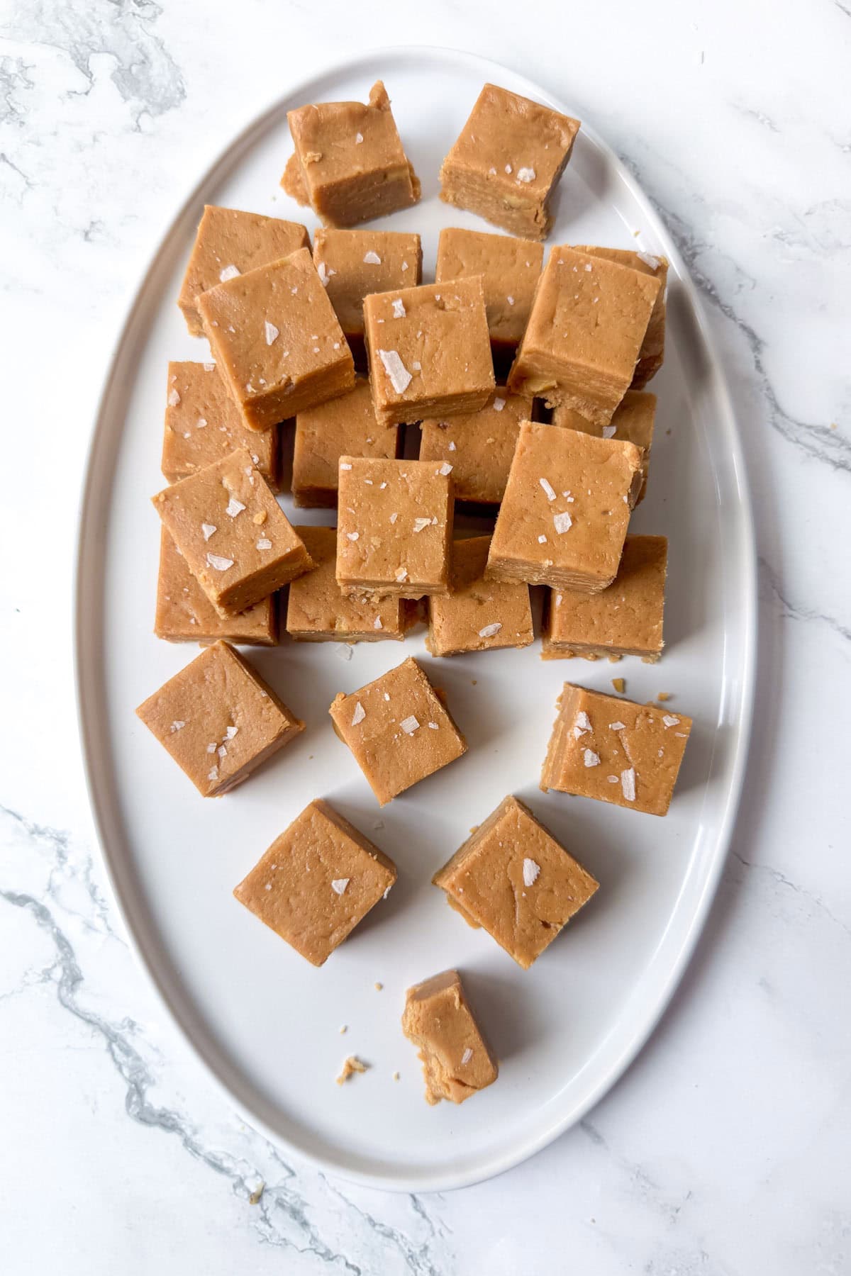 Cut pieces of peanut butter fudge on an oval serving plate