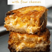 Close up view of a cut grilled cheese sandwich with a title overlay saying Gourmet Grilled Cheese with Four Cheeses at the top and www.nextlevelbaker.com at the bottom
