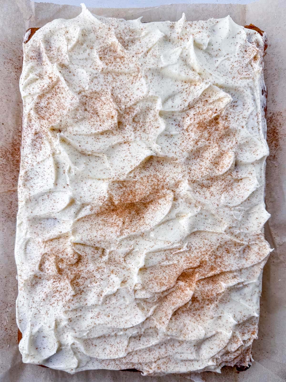 Overhead view of GF pumpkin bar cake that has had pumpkin pie spice sprinkled on top