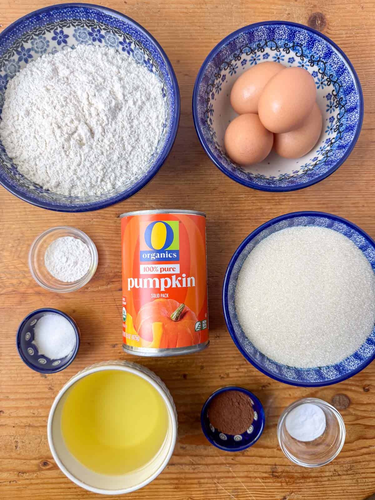 Ingredients needed for the gluten free pumpkin bar cake: gluten free one-for-one flour, white sugar, pumpkin puree, eggs, vegetable oil, baking soda, baking powder, cinnamon and salt