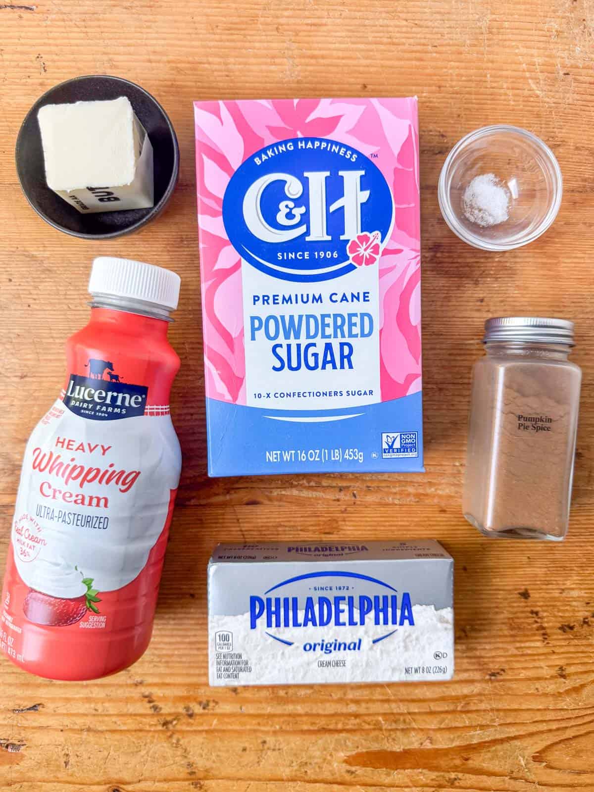Ingredients needed for cream cheese frosting: cream cheese, salted butter, powdered sugar, heavy whipping cream, salt (optional), pumpkin pie spice