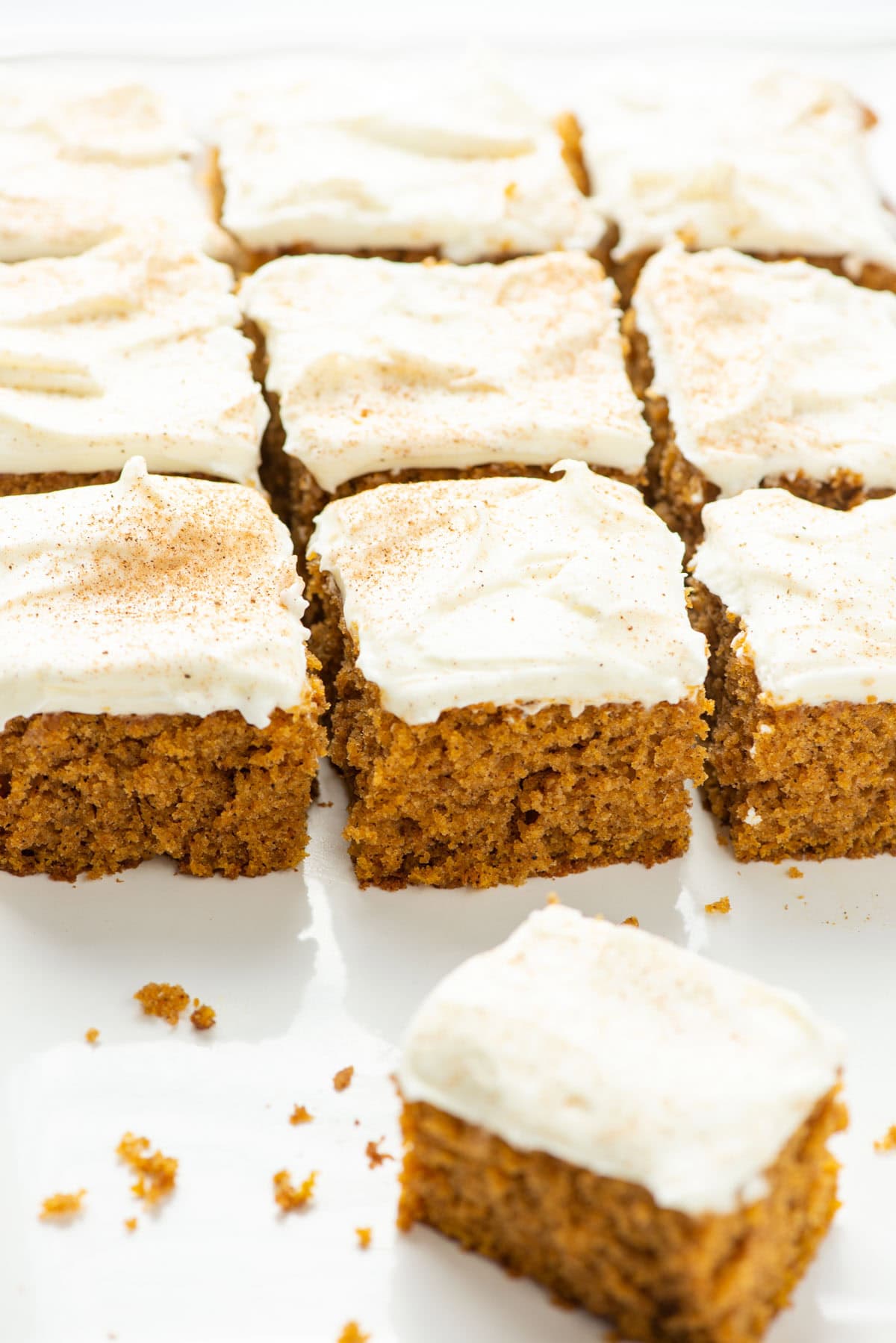 Slices of gluten free pumpkin cake on a serving platter with one slice in front turned diagonally
