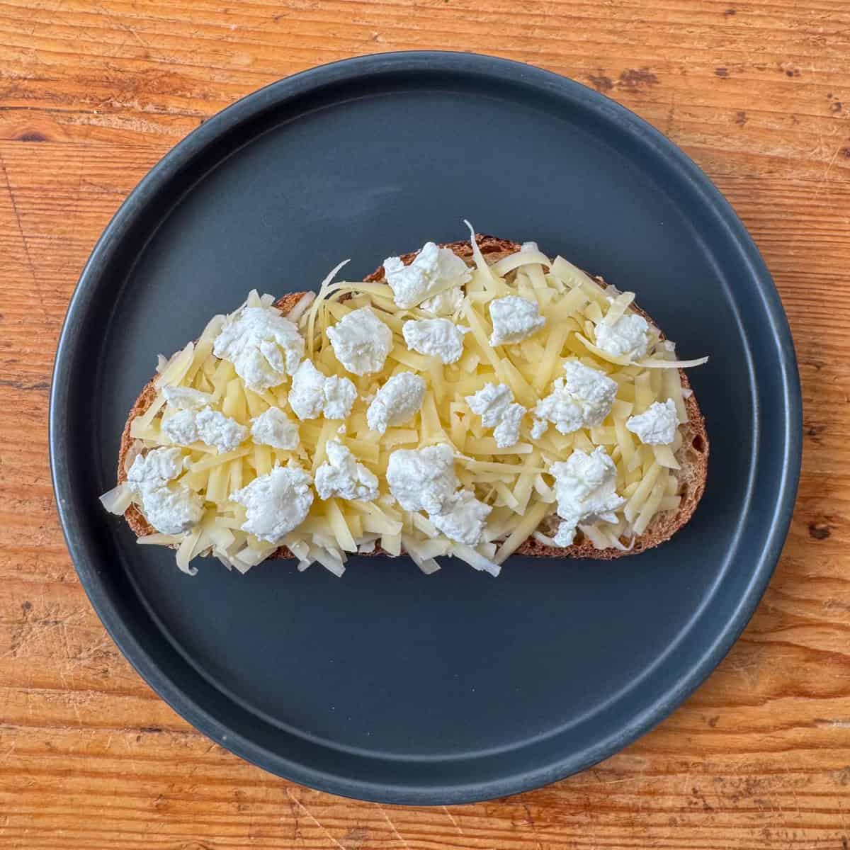 Step 2 of making a four cheese grilled cheese: adding the goat cheese