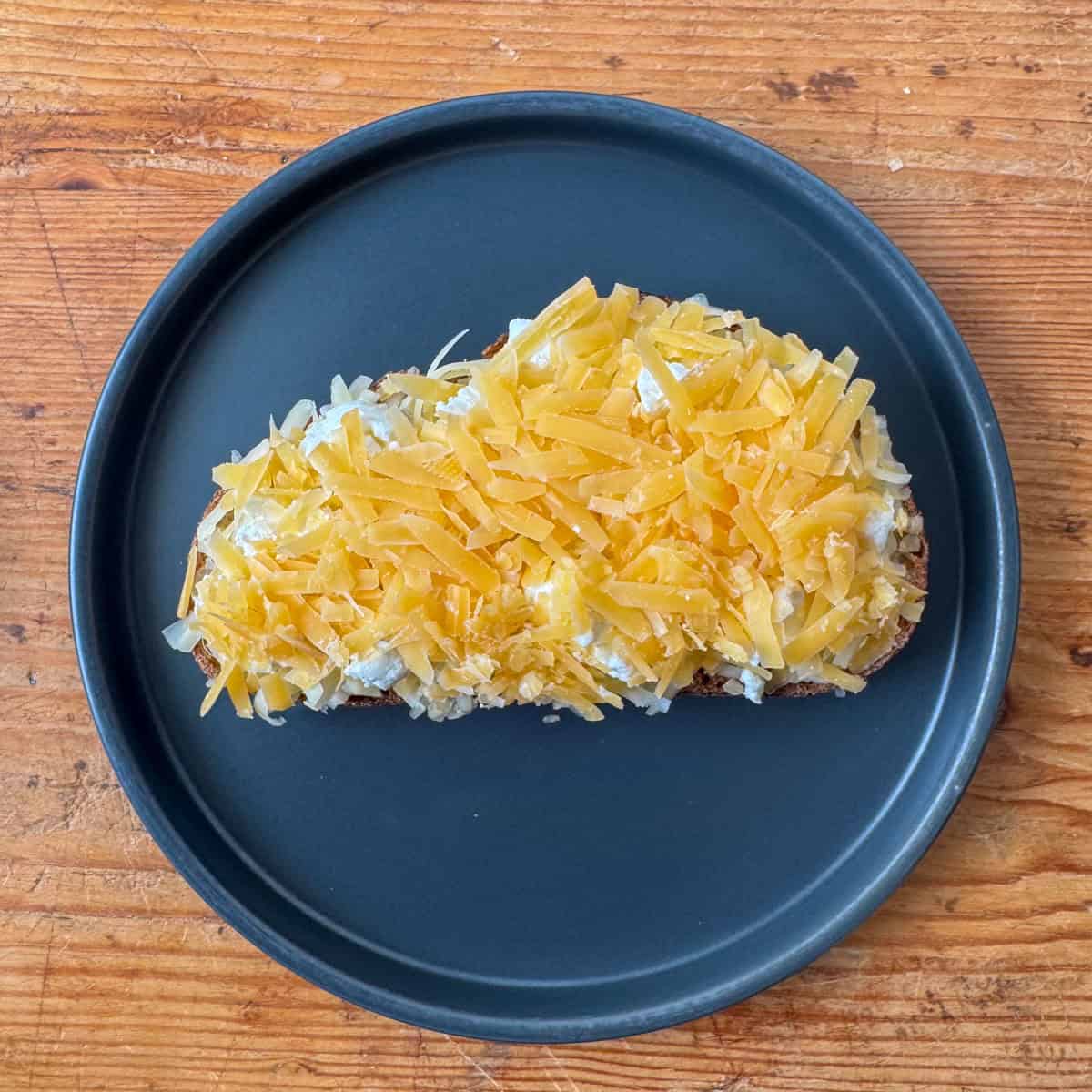 Step 3 of making four cheese grilled cheese: adding the gouda cheese