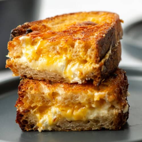 Close up photo of a cut grilled cheese sandwich stacked on top of each other