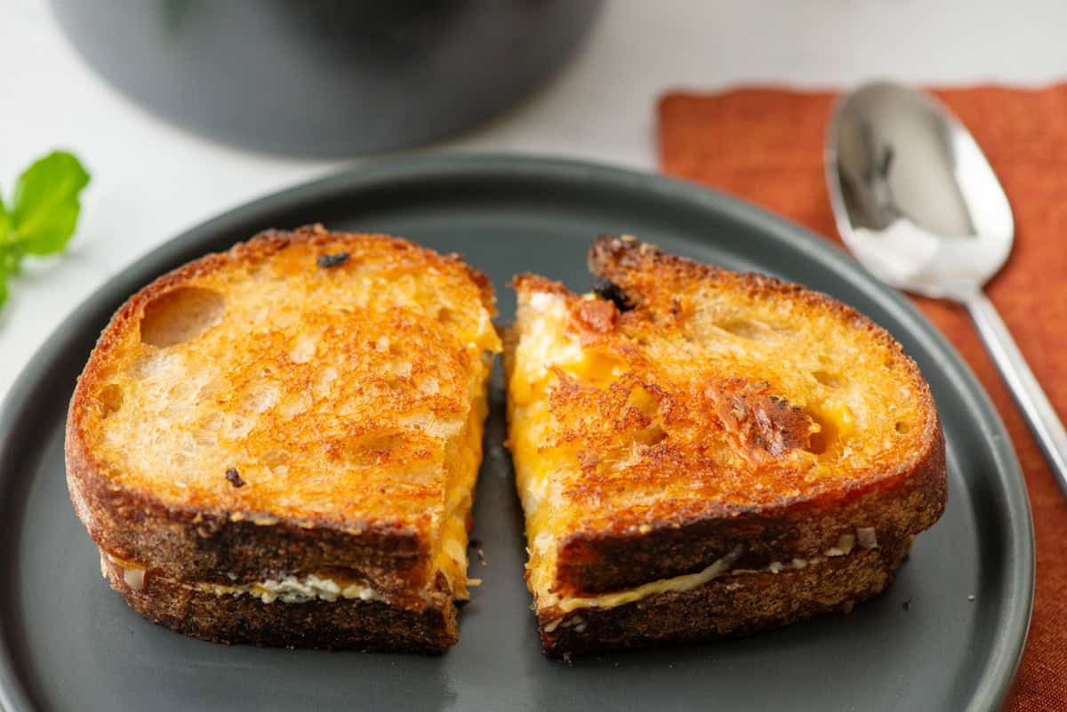 Top view of a grilled cheese sandwich that's been cut in half on a plate