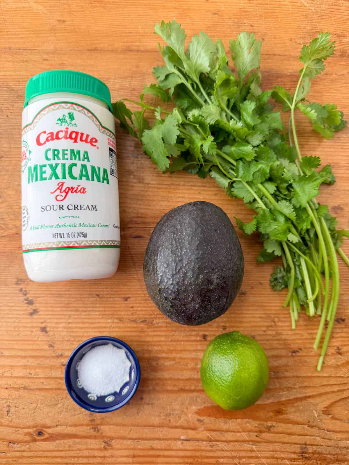 Ingredients needed for avocado lime crema: Mexican crema, avocado, cilantro, lime and salt