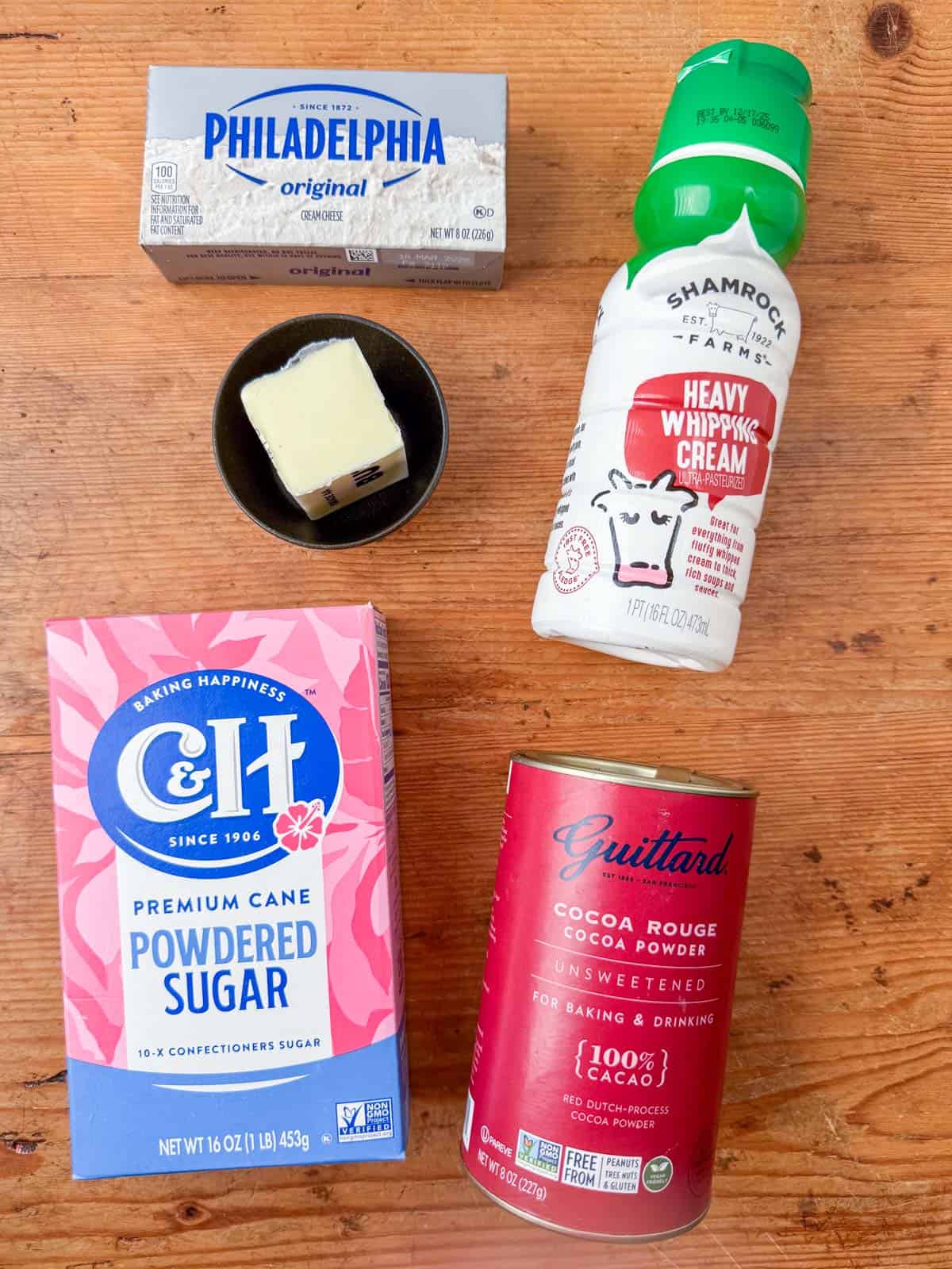 Ingredients needed to make chocolate cream cheese frosting: cream cheese, salted butter, powdered sugar, cocoa powder, heavy whipping cream