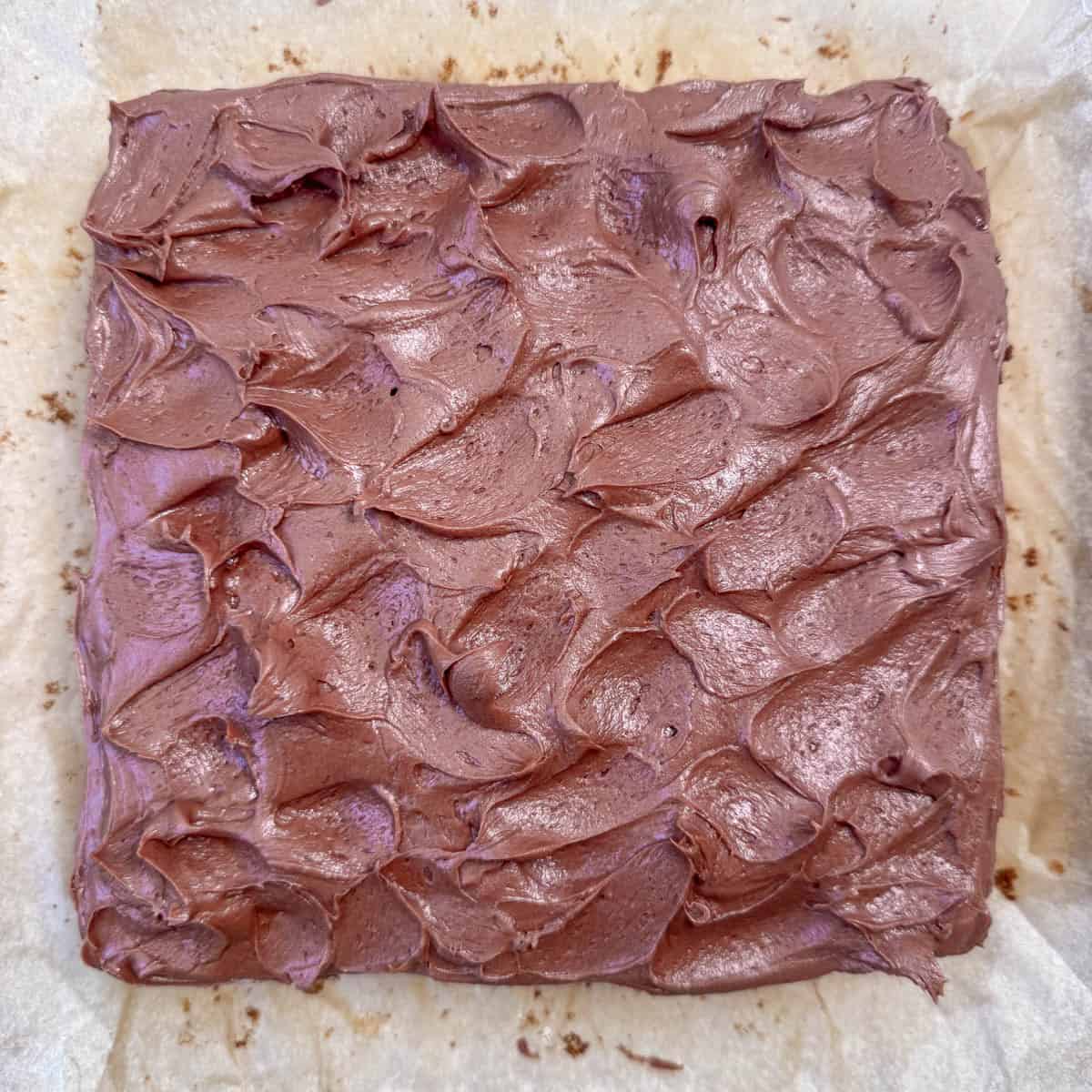 Overhead photo of the top of the cake showing step two of frosting the cake: making waves in the frosting