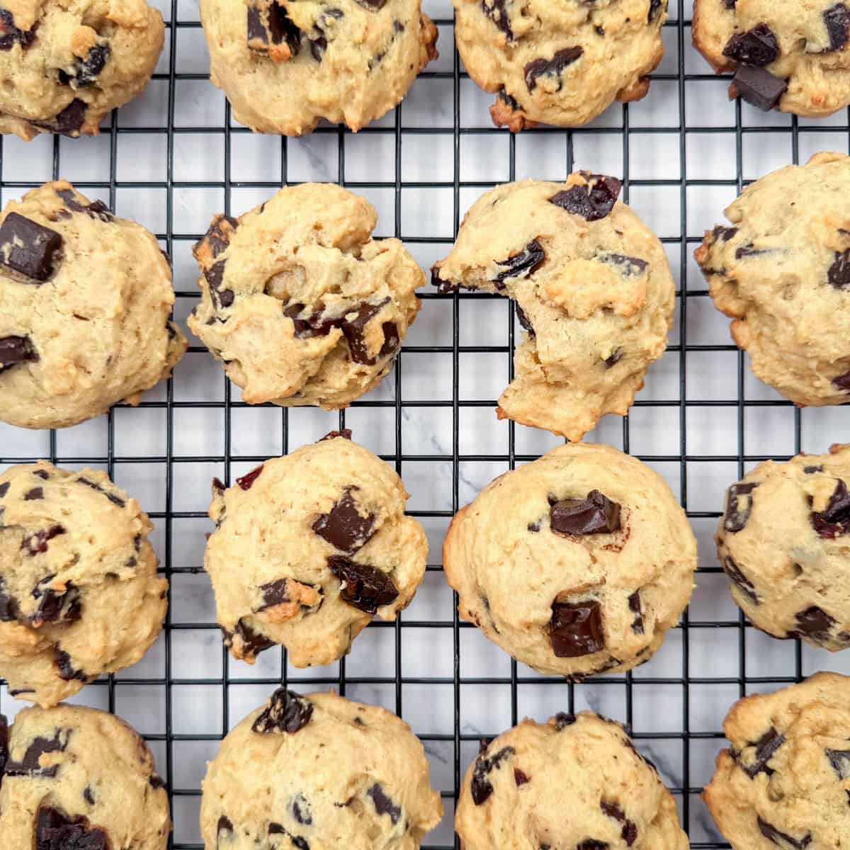 Overhead close up photo of cherry chocolate chunk cookies on a cooling rack