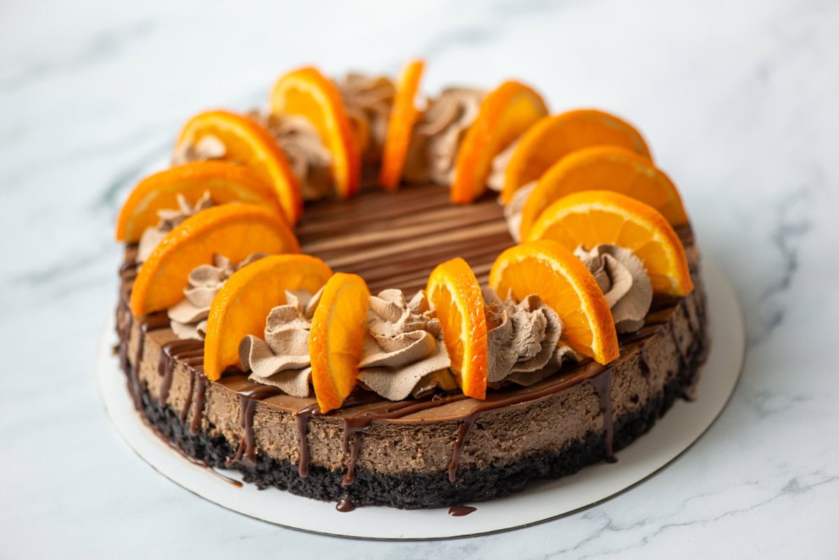 Overhead view of a full and decorated chocolate orange cheesecake