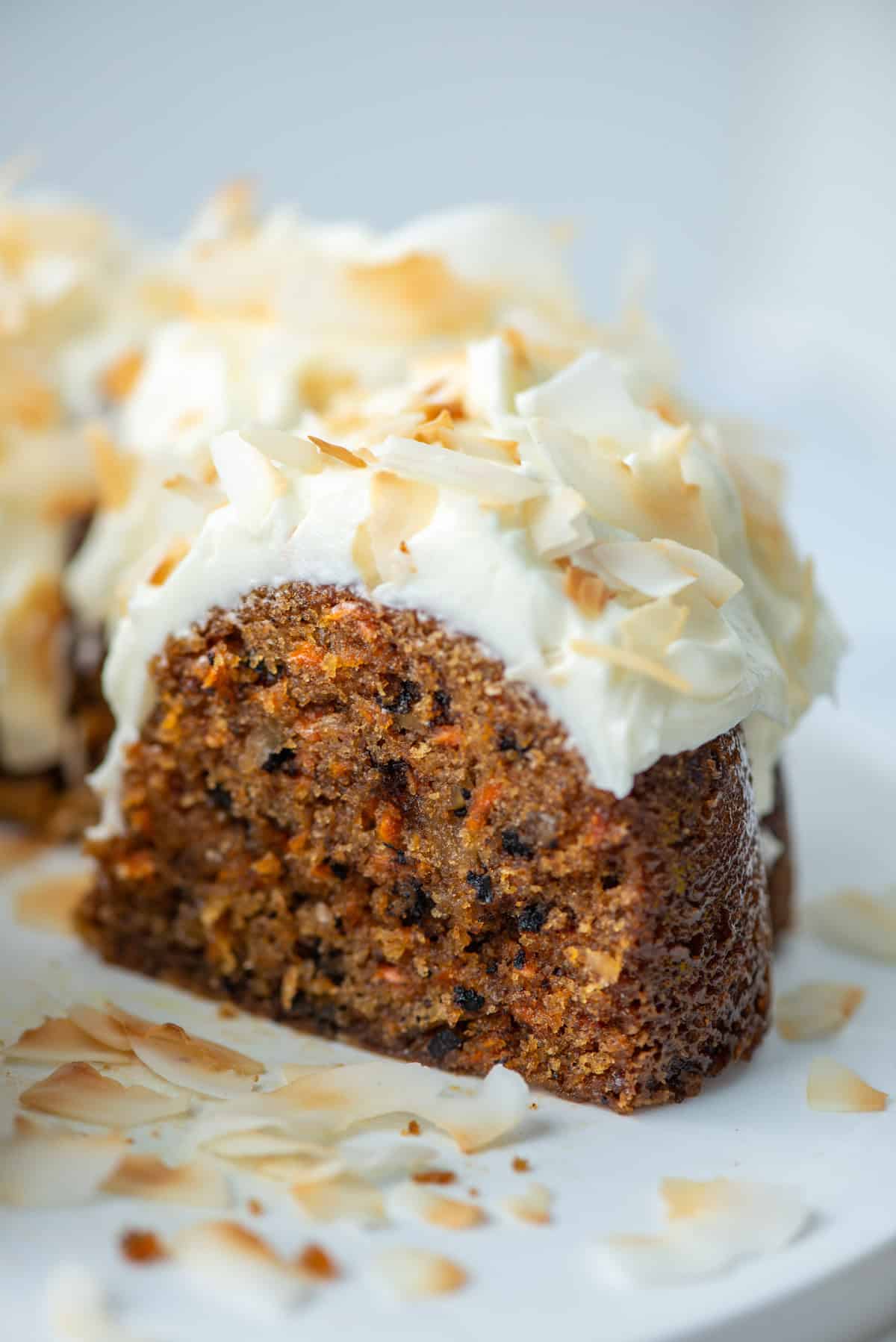Side view of a section of the carrot bundt cake so that you can see the inside of the cake