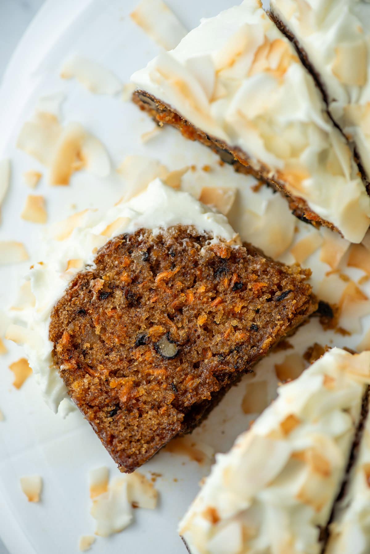 Overhead view of a slice of carrot bundt cake on its side among other slice of the cake that are still upright
