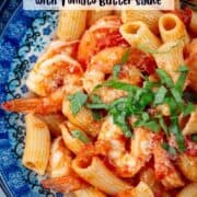Very close up photo of shrimp riagorin with tomato butter sauce with a title overlay that says Shrimp Rigatoni with Tomato Butter Sauce