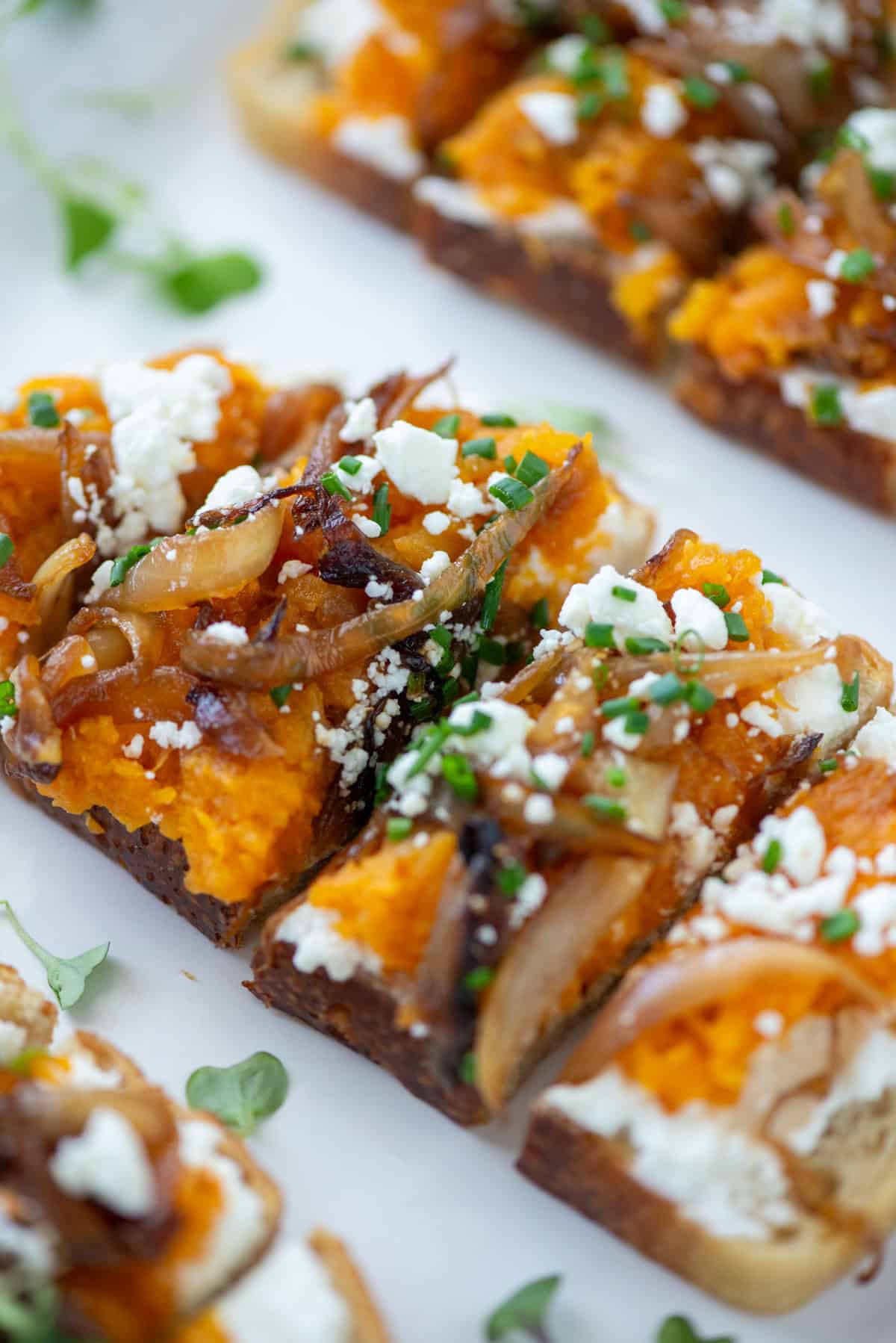 Close up view of angled squash toast sliced in quarters