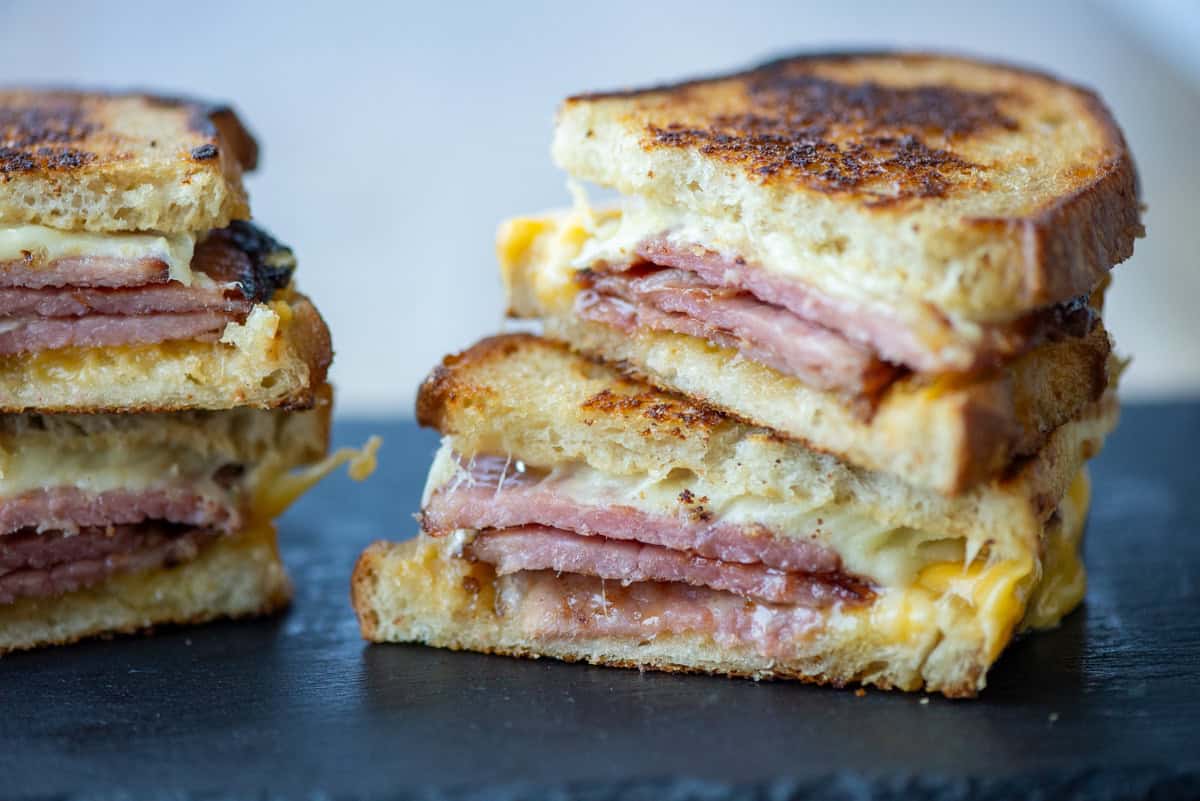 Side view of one and a half grilled cheese sandwiches cut in half and stacked on top of each other
