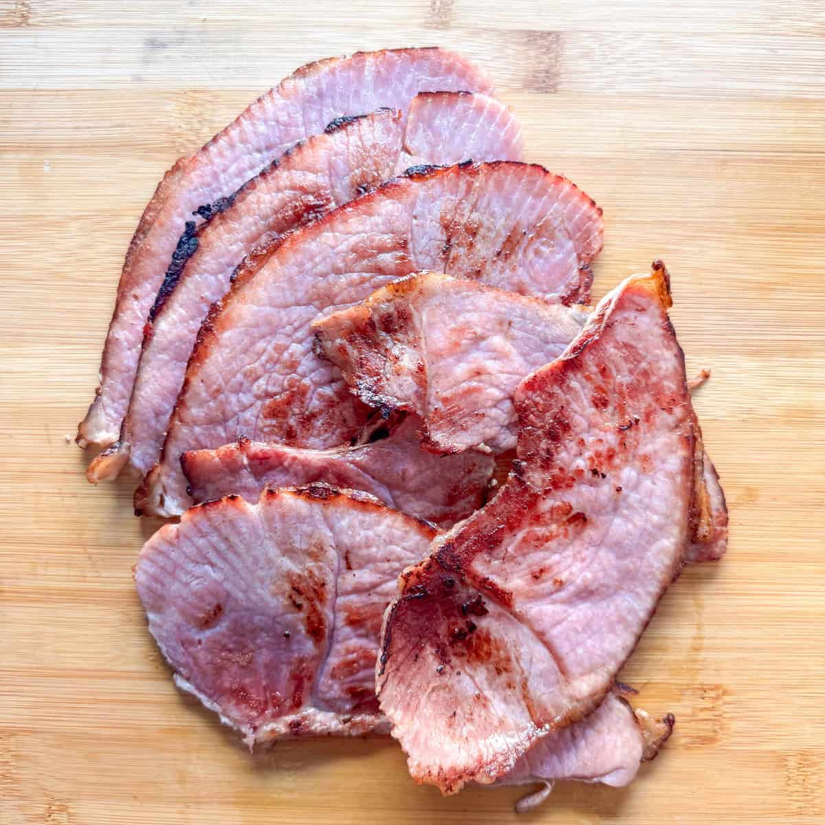 Photo showing grilled ham on a cutting board