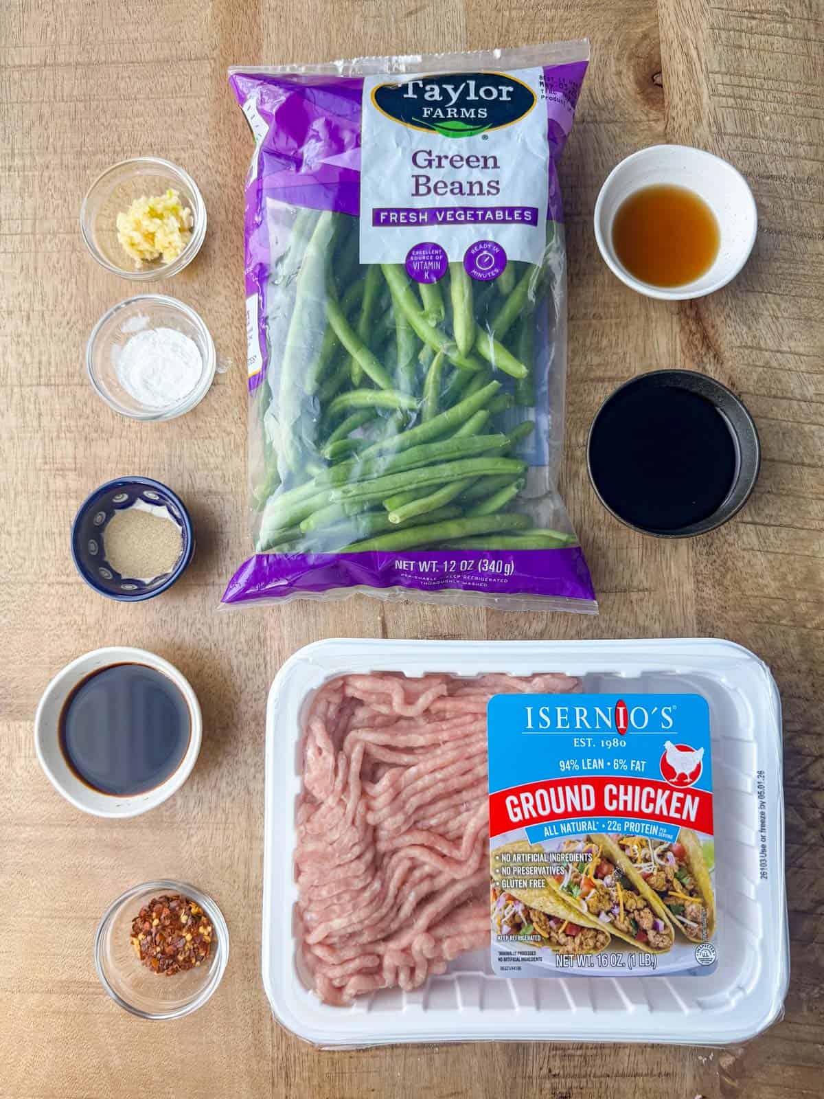 Ingredients needed for spicy ground chicken stir fry with green beans: ground chicken, green beans, sesame oil, ground white pepper, cornstarch, diced garlic, crushed red peppers, mushroom sauce and soy sauce.