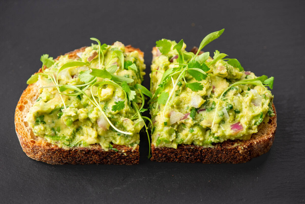 Guacamole spread on a slice of toasted bread