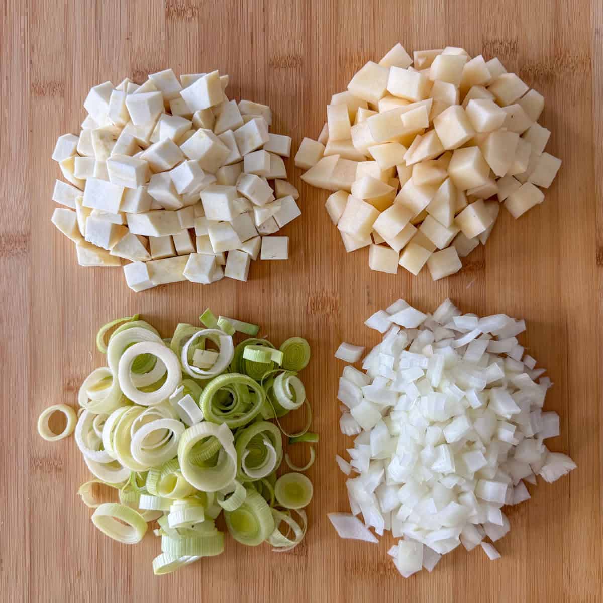 Diced potatoes, celery root, leeks and onions on a cutting board