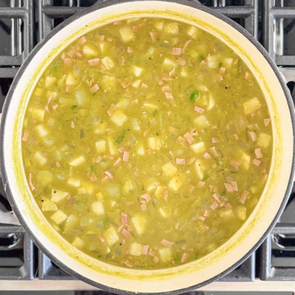 Overhead photo of soup in the pot on the stove when it's just finished cooking and still very hot.