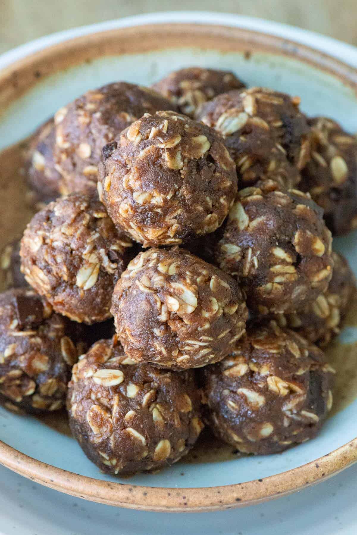 Overhead angled image of stacked chocolate protein powder balls on a plate